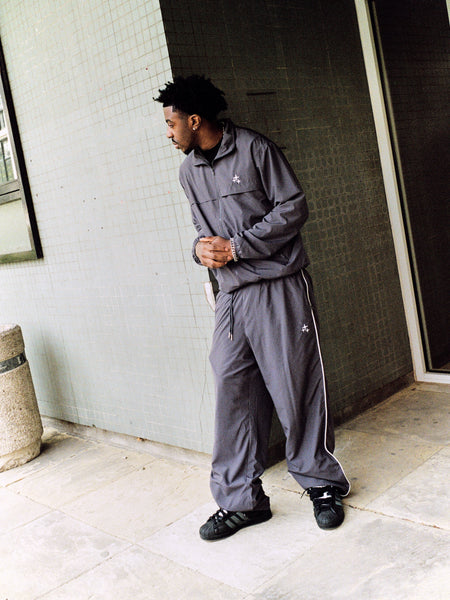 Model wearing ash grey Drama Call STA baggy nylon pants