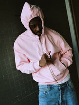 Model wearing light pink drama zip hoodie - streetwear look