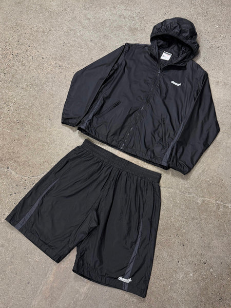 Black Drama Call 1sta ripstop lightweight shorts and matching jacket set, flat lay view.