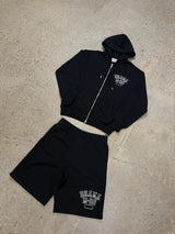 Men's black Drama Call distressed college zip-up hoodie and shorts set, flat lay view.