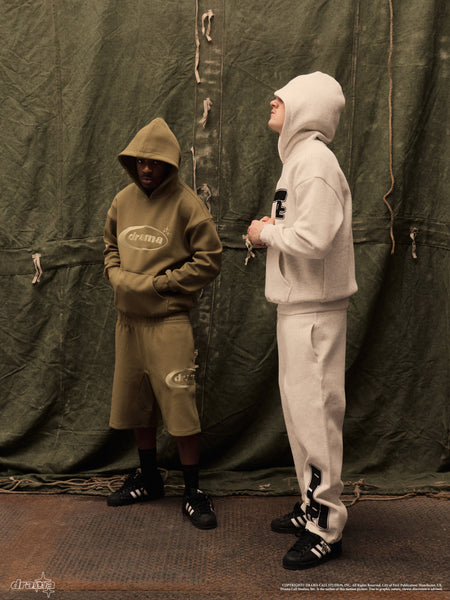 Two models wearing green and grey Drama Call hoodies