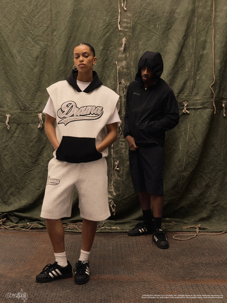Model wearing the grey Drama Call stud script vest hoodie