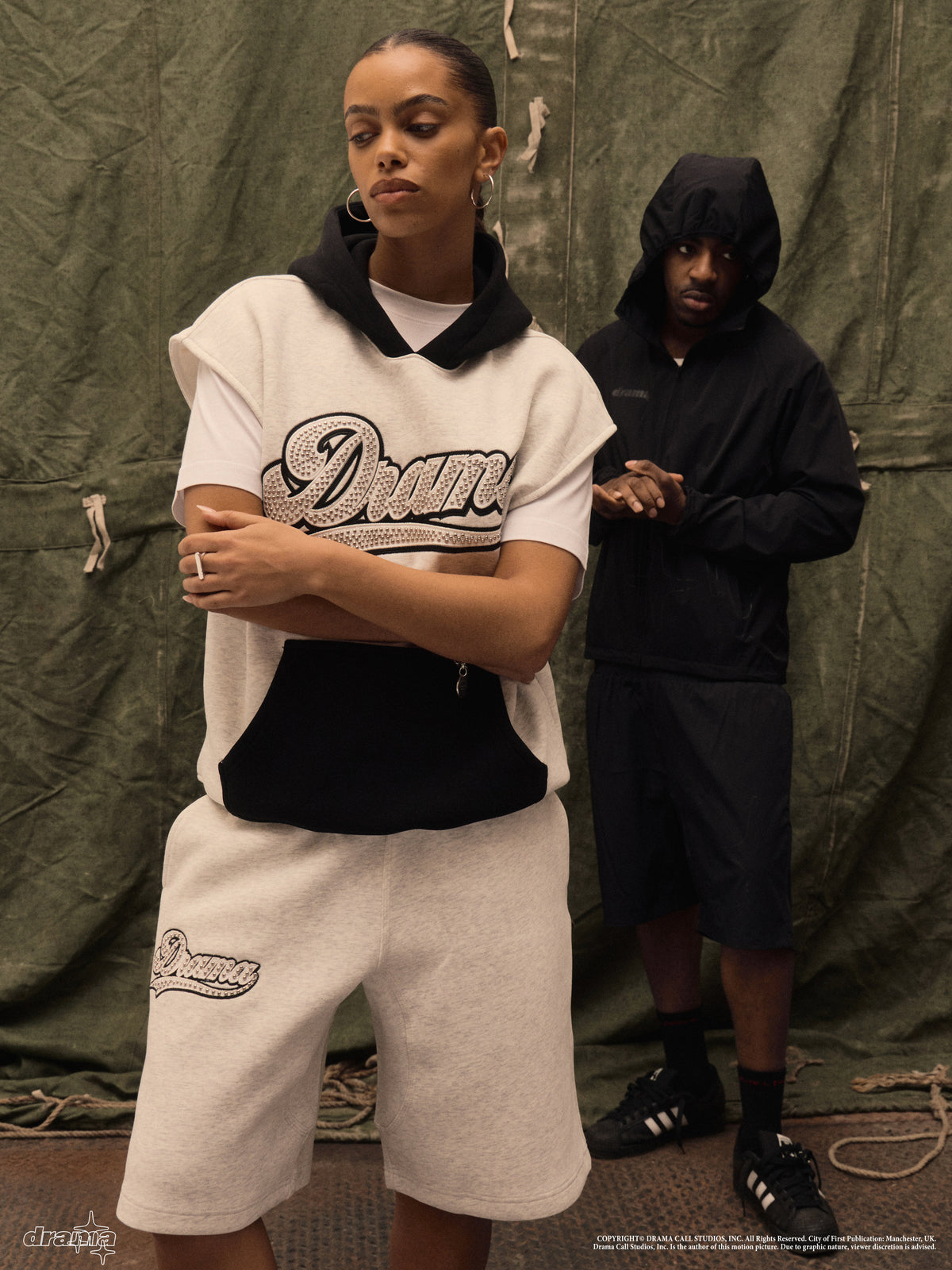Model wearing the grey Drama Call Stud Script vest hoodie