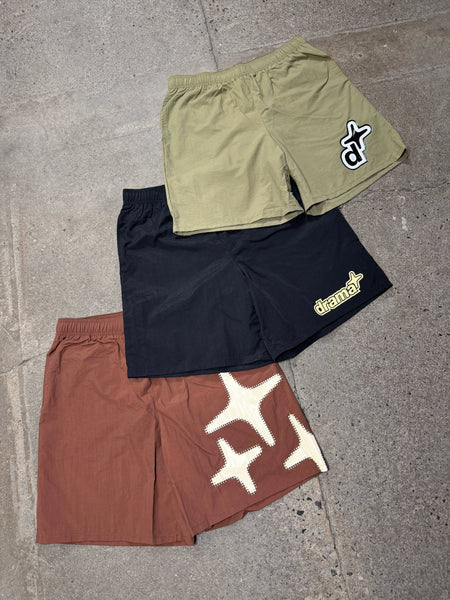 Men's olive, black, and brown Drama Call swim shorts laid flat