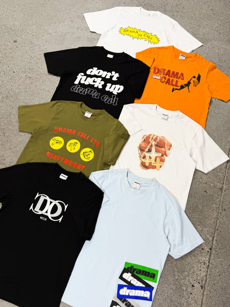 Flat lay view showcasing an assortment of men's Drama Call graphic tees