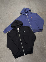 Men's navy STA and black waffle zip-up hoodies in a flat lay view.