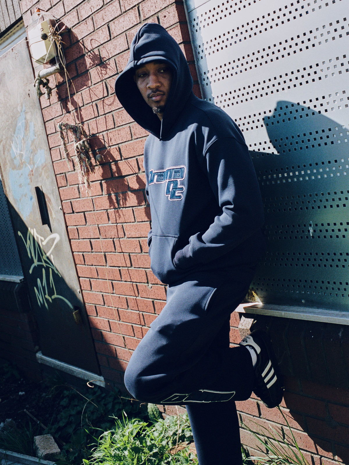 Model wearing the navy Drama Call AV Sport mens hoodie