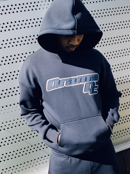 Model wearing a navy Drama Call AV Sport hoodie