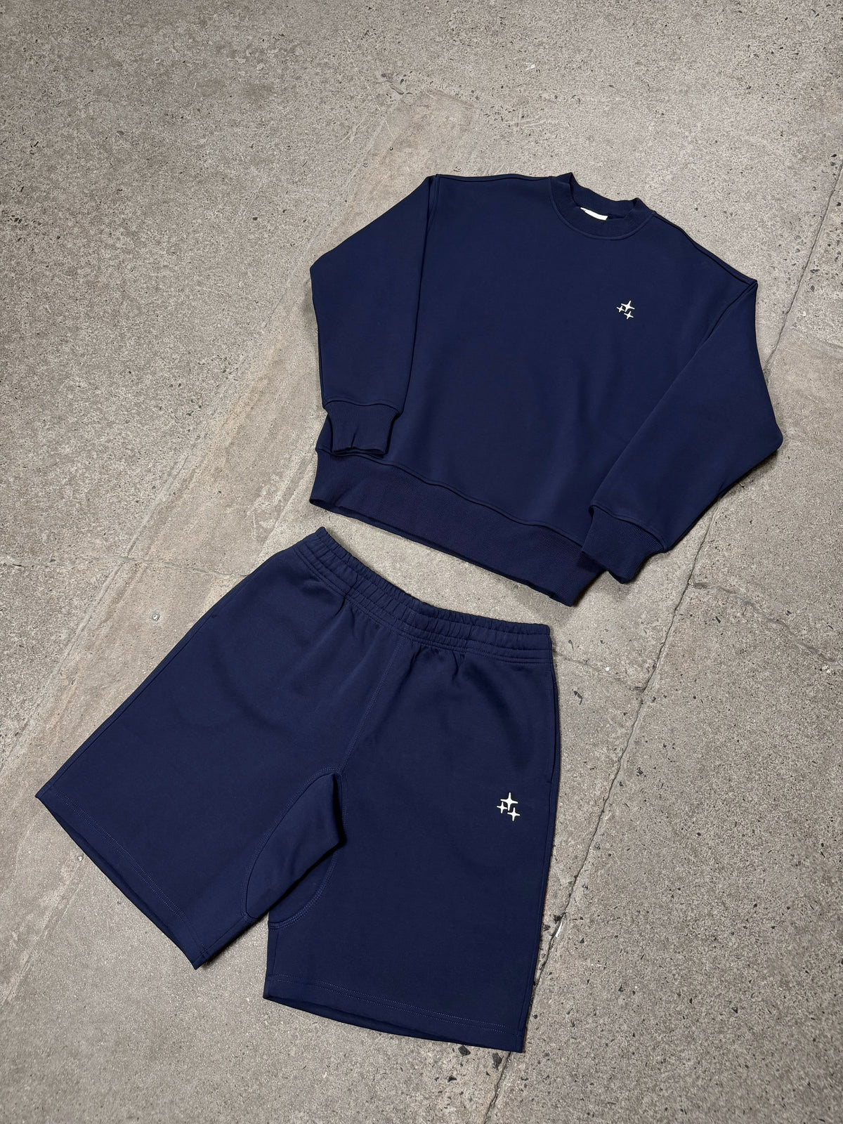 Men's navy Drama Call STA crewneck sweatshirt and matching shorts in a flat lay view.