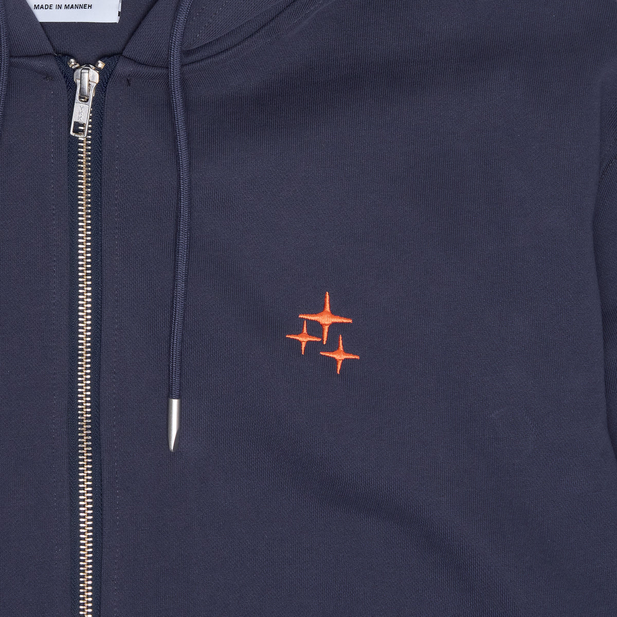 Close up view of the navy Drama Call STA zip-up hoodie