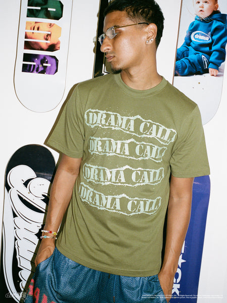 Model wearing the olive green Drama Call D-Team graphic tee