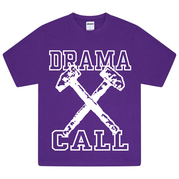Men's purple Drama Call Hammer graphic tee flat lay showing the front design with crossed hammers and block lettering.